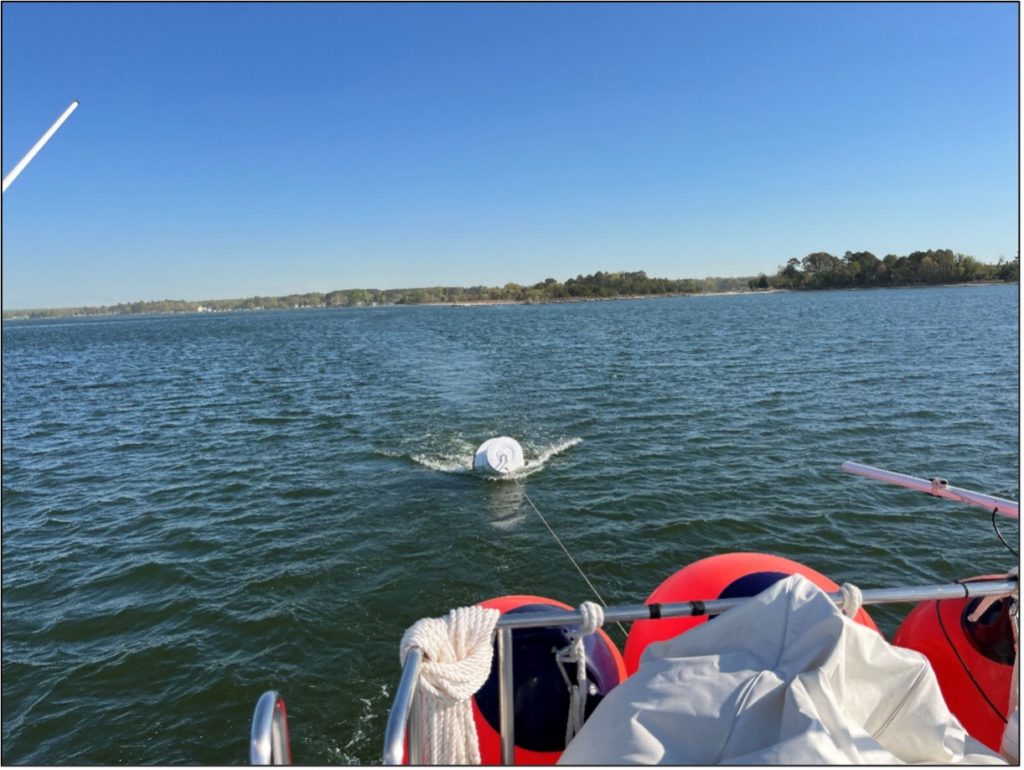 Deceptive calm, slight NNE wind starting up and pushing us downriver with the buoy in tow.