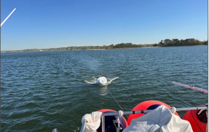 Deceptive calm, slight NNE wind starting up and pushing us downriver with the buoy in tow.