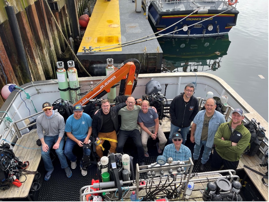 Nine BAREG divers aboard Huskyan after loading our gear upon arrival in Stromness.